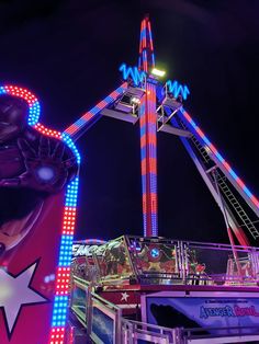 an amusement park ride lit up at night