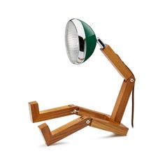 a green and white lamp sitting on top of a wooden stand