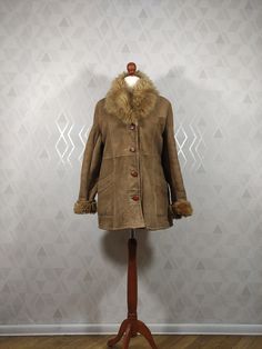 This is a very well preserved genuine sheepskin jacket. The jacket is in good vintage condition.  The jacket has two pockets on the sides. Made in Poland Dimensions: total length: 78cm sleeve length from collar: 75 cm sleeve from armpit: 43  cm chest: 2x54 cm in waist: 2x 48 cm Vintage Leather Jacket For Winter, Vintage Sheepskin Leather Jacket For Fall, Vintage Leather Jacket With Faux Fur Lining For Winter, Vintage Shearling Leather Jacket For Fall, Vintage Leather Jacket With Faux Fur Lining, Vintage Winter Shearling Outerwear, Vintage Shearling Leather Jacket With Faux Fur Lining, Brown Sheepskin Fur Coat With Pockets, Vintage Leather Fur Coat