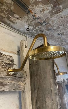 an old light hanging from the ceiling in a room with peeling paint and chipped walls