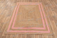 a pink and beige rug on the floor