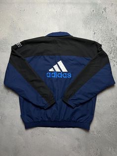 Vintage Adidas Track Jacket 90's Nylon Retro Windbreaker Size Men's / US L / EU 52-54 / 3 Color Navy blue Condition Gently Used Adidas 80s Rare Track Jacket Tactel 00s In a good condition. Fast sending! Condition : 9/10 Chest - 68 cm Lenght - 72 cm Sleeve length from neck - 84 cm Sleeve length from armpit - 55 cm - ALL ITEMS ARE HEAT TREATED AND WASHED BEFORE SHIPPING - FOLLOW MY STORE - SEE MY OTHER ITEMS Retro Windbreaker, Adidas Vintage, Retro Jacket, Adidas Track Jacket, Logo Line, Y2k Jacket, Adidas Track, Vintage Adidas, Track Jacket