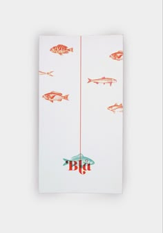 a white towel with fish on it and the word big written in red letters, hanging from