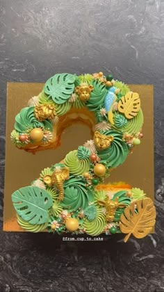 the letter s is made out of green and yellow paper flowers, leaves, and acorns