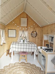 a bed in a room with wooden walls and white flooring next to a stove top oven