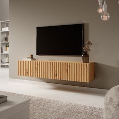 a living room with a large television mounted on the wall