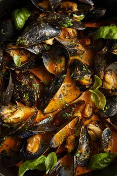 steamed mussels with herbs and spices in a pan