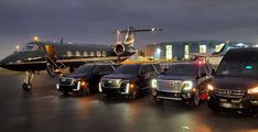 several luxury vehicles parked in front of an airplane