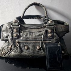 This Is A Vintage Grey Gsh Balenciaga City Part-Time Bag! It Has Giant 21 Silver Hardware And Is Made Of Grey Leather Which Is Beautifully Distressed. This Style Comes With A Removable Shoulder Strap (Not Pictured) And Matching Mirror. Measures 17" Across, 9.5" Tall And 6" Deep. Hard To Find Color And Style! Bundle And Save Or Make Me An Offer!Can Ship Same Day Mon-Fri If Payment Is Received Before 9:00pm Est Or Saturdays Before 1:00pm Est! Balenciaga Giant City Bag, Vintage Balenciaga, Style Bundle, Grey Bag, Find Color, Part Time, Grey Leather, Silver Hardware, Balenciaga