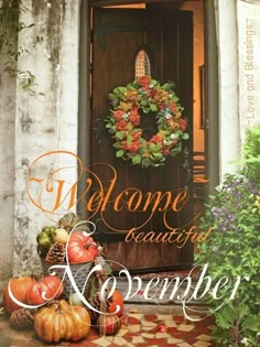 the front door to a home with pumpkins and flowers on it, next to a welcome sign