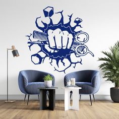 a living room with two chairs and a wall sticker that has a fist on it