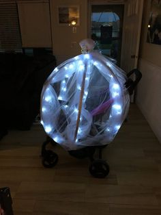 a light up umbrella sitting in the middle of a living room next to a door