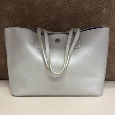 Price Is Firm In Very Good Condition! Has Some Glue Residue On The Leather. Minor Creasing. 14.5”W * 6”D Base 18.5” Top Opening 11”H 9.5” Strap Drop Tory Burch Bags, Tory Burch Bag, 6 D, Metallic Leather, Womens Tote Bags, Leather Tote, Metallic Silver, Tory Burch, Glue