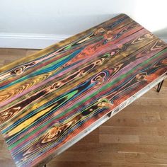 a wooden bench sitting on top of a hard wood floor