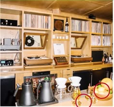 an old record player sits on top of a wooden shelf