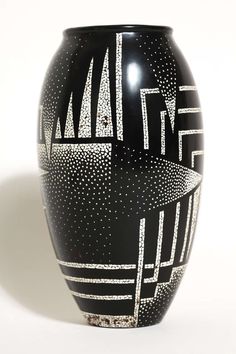 a black and white vase sitting on top of a table