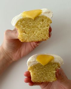 someone holding two pieces of cake with eggs on them and one piece has been cut in half