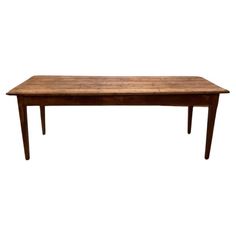 a wooden table with two legs and a long, narrow top on an isolated white background