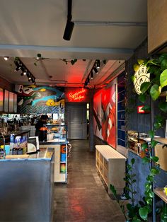 the inside of a restaurant with plants growing on the walls