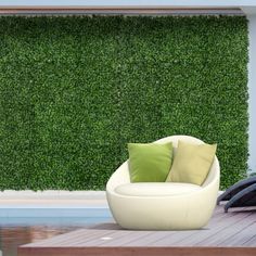 a white chair sitting on top of a wooden floor next to a pool and green wall