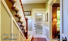 an entry way leading to a home with wood flooring and white trimmings