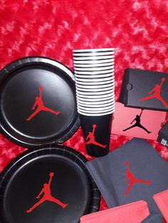 black and red paper plates, napkins, and coasters with jordan logo on them