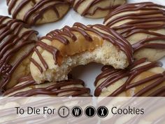 a white plate topped with cookies covered in chocolate drizzled on top of each other