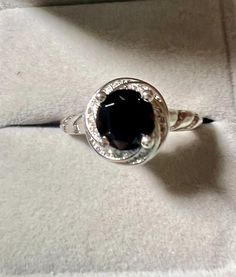 Gemstone:  genuine natural round cut black spinel Size: 8mm x 8mm Weight: 2.05cts approximately  Metal: .925 stamped Sterling Silver, rhodium plated Size: 10 Black Round Sapphire Ring For Anniversary, Black Birthstone Rings, Classic Black Spinel Sapphire Ring For Anniversary, Classic Black Sapphire Ring In Sterling Silver, Black Round Jewelry With Accent Stones, Black Jewelry With Accent Stones, Black Oval Sapphire Ring With Center Stone, Black Sapphire Ring With Oval Center Stone, Black Sapphire Ring For Formal Occasions