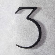 the number five is made out of black metal on a white surface with grey background