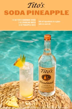 a bottle of soda sitting next to a glass filled with ice and lemonade on top of a wicker table near a swimming pool