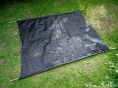 a black tarp is laying on the grass