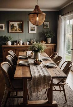 a dining room table is set with plates and place settings