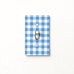 a blue and white checkered light switch cover