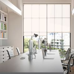 an empty conference room with chairs and desks in front of large windows overlooking the city