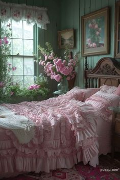 a bed with pink ruffled bedspread in a green room