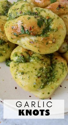 garlic knots on a white plate with the words garlic knots overlaying it's image