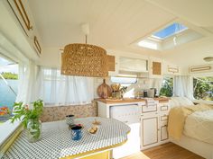 the interior of a tiny house with a bed, sink and kitchenette in it