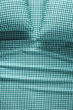 a close up view of the green and white checkered sheets