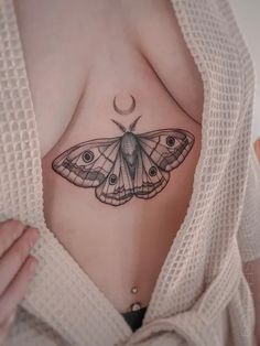 a woman's stomach with a butterfly tattoo on it, and the bottom part of her breast