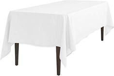 a white table cloth on top of a wooden table