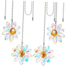 three necklaces with flowers hanging from chains