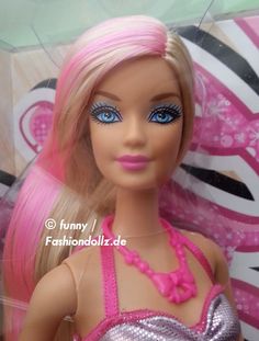 a barbie doll with pink hair and blue eyes