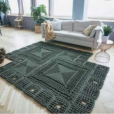 a living room with a couch and rug on the floor