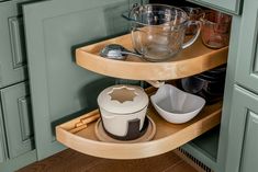 a corner shelf in a kitchen with bowls and measuring cups on it's sides