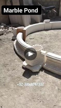 a white bench sitting on top of a cement ground