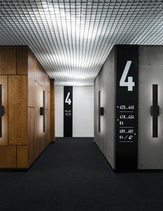 an empty hallway with black and white numbers on the wall