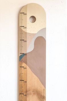 a wooden ruler with an abstract painting on it