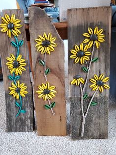 three wooden boards with painted flowers on them