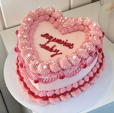 a heart shaped cake sitting on top of a table