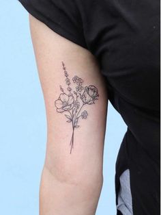 a woman with a flower tattoo on her arm